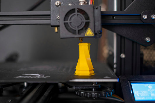 Close-up of an FDM 3D printer nozzle printing with PLA filament
